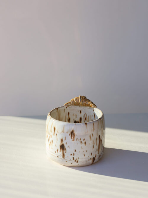 white brown speckles croissant cappuccino cup