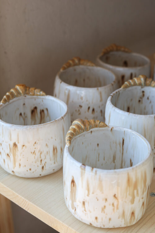 white brown speckles croissant cappuccino cup